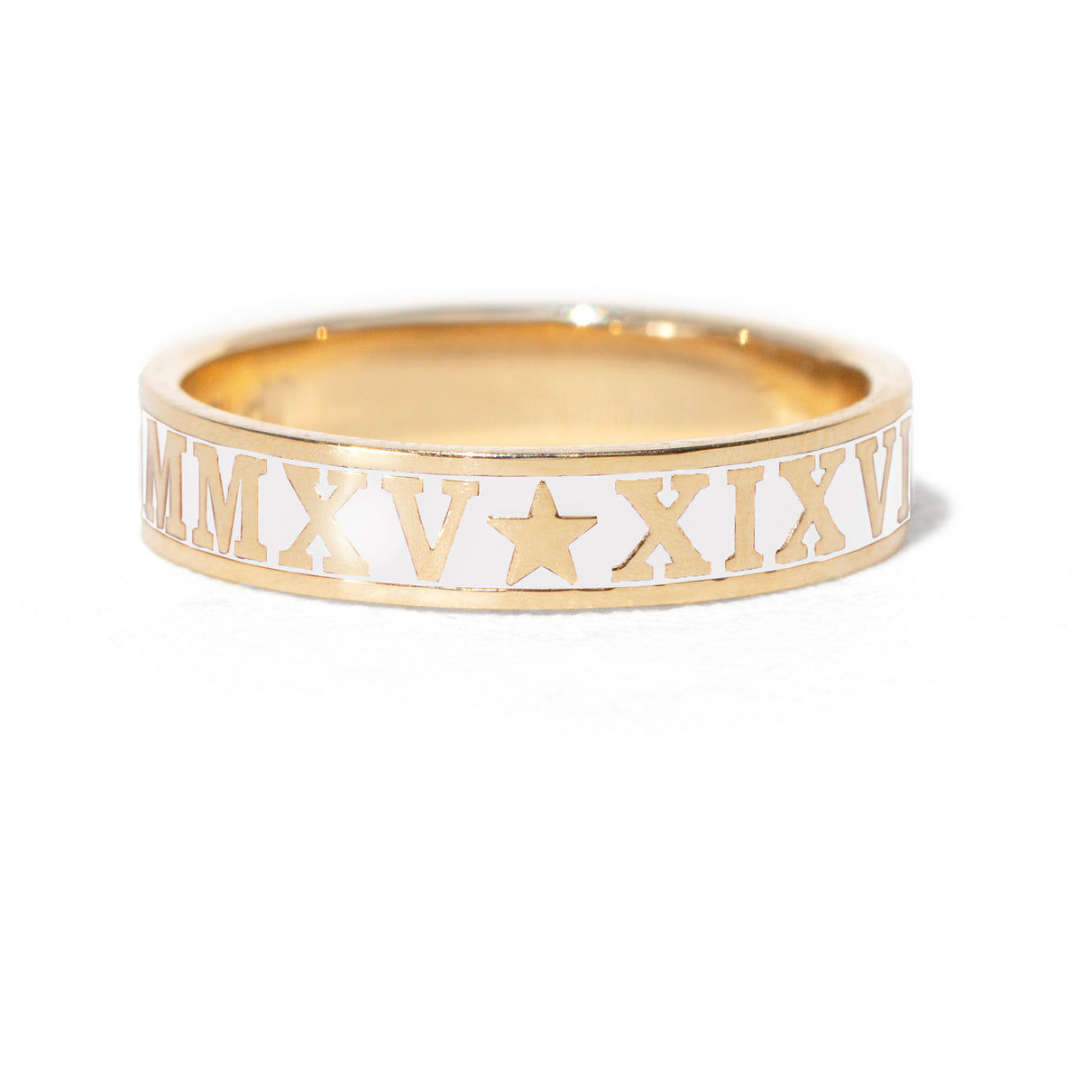 Gold ring with Roman numerals and star design on a white background