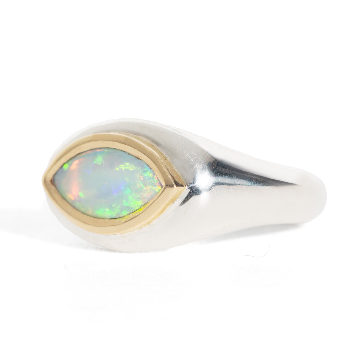 Silver ring with a gold accent and opal stone on a white background