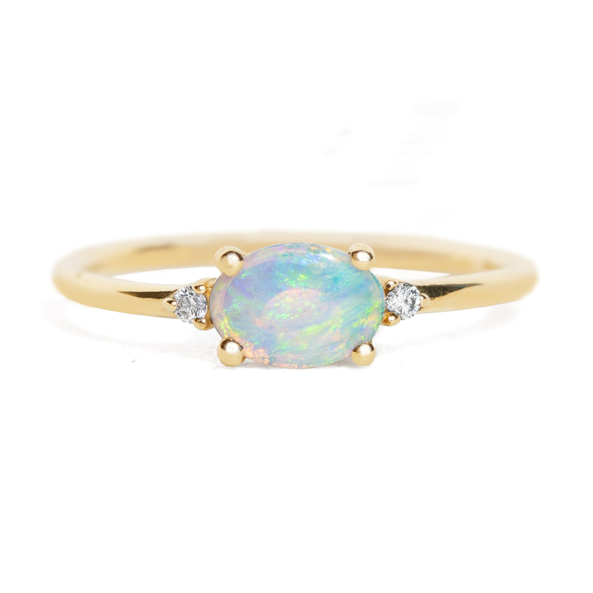Gold ring with a central opal stone and smaller diamonds on a white background