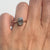 Old mine cut diamond ring on a a hand against  white background. 