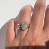 Old mine cut diamond ring  and two gold bands on a hand against  white background. 