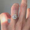 Emerald cut diamond ring on a finger 