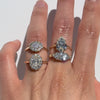 Four diamond rings on a hand against white background.