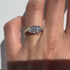 Gold ring with a large marquise shaped diamond on a white background
