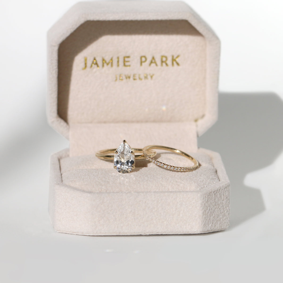 Jamie Park Jewelry - 2ct Pear Cut Lab Diamond Ring Jamie Park Jewelry | Sunshine Pear Cut Ring The Sunshine Pear Cut Solitaire Ring beautifully blends modern style with elegance. Available with lab white sapphire, moissanite, or IGI certified diamond, this ring is sure to sparkle and impress. The five-prong design ensures the center stone is securely held. The size shown is 2.5ct.